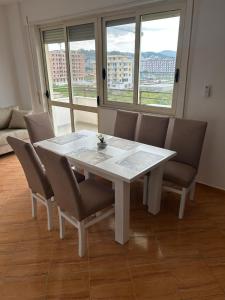 a white table and chairs in a room with windows at Kristal in Golem