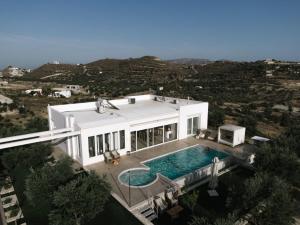 an aerial view of a house with a swimming pool at Koronio Villas in Kalamaki