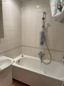 a bathroom with a bath tub with a shower at Сozy accommodation in Sillamäe