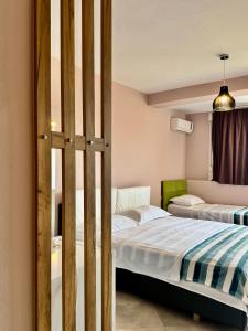 a bedroom with two beds and a window at FishLand Seaside Apartments in Durrës