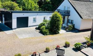 an overhead view of a white building with a garage at HOSTEL 66 Bremerhaven Geestland in Imsum