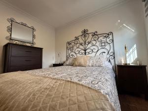 a bedroom with a large bed with a large headboard at La Planta Vieja III in La Orotava