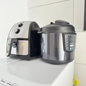 a slow cooker and toaster sitting on a kitchen counter at 47NV Studio Liberdade SP 300 mts Metro Japão, acomoda até 03 pessoas in Sao Paulo +39 photos