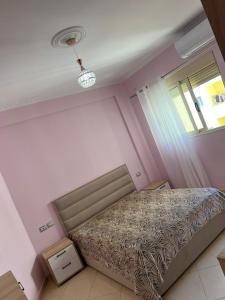ヴロラにあるSoni Apartmentsのベッドと窓のある寝室