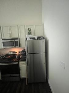 a kitchen with a stainless steel refrigerator and a stove at Luxury Apartment UConn in Storrs