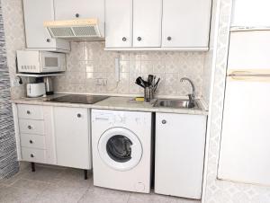 a kitchen with a washing machine and a sink at Benalmádena Nice Sea Views ! in Benalmádena