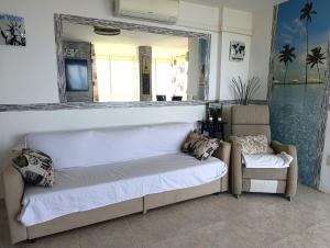 a bed in a room with a mirror and a chair at Benalmádena Nice Sea Views ! in Benalmádena +10 photos