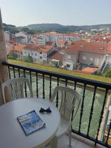 a table and chairs on a balcony with a view at Apartamento Perla 2000 in Portonovo