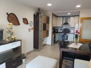 a kitchen with a table and a dining room at Apartamento Perla 2000 in Portonovo