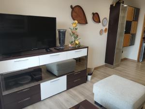 a living room with a large entertainment center with a flat screen tv at Apartamento Perla 2000 in Portonovo