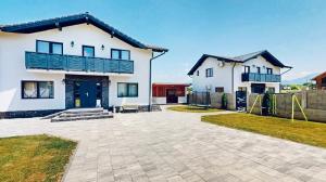 a large white house with a patio in front of it at D&M Family Residence Bran 1 in Bran