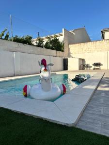 a pool with an inflatable animal in the water at Can Guzmu in Cijuela