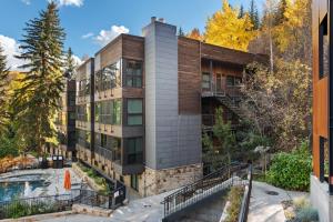 an exterior view of a building with a pool at Durant Unit C2, Condo with Designer Finishes, Great Views & Location in Aspen