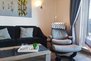 a living room with a couch and a chair at Insider in Eckernförde