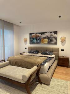 a bedroom with a large bed and a couch at Villa Hana - San Pietro in Fushë-Draç +13 photos