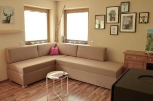 a living room with a couch and a table at Hollys Ferienwohnungen in Gerlos