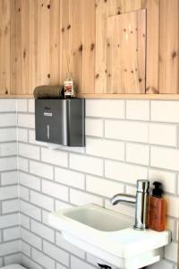 a kitchen with a sink and a microwave at Bell Tent Village Parks in Nottingham