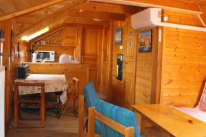 a kitchen and dining room in a log cabin at Hungaria Guesthouse in Budapest