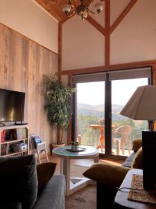 a living room with a couch and a table at Cara norte de Gredos in Hoyos del Espino