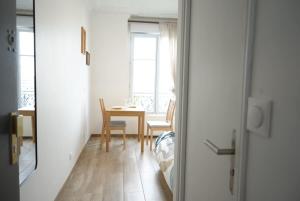 a room with a table and a dining room at Vaugirard1 Appt Paris 15, Eiffel Tower View in Paris