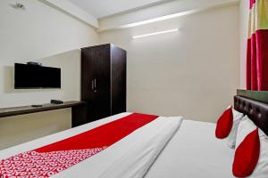 a bedroom with a bed and a tv on the wall at Hotel O SR PALACE in Bārang