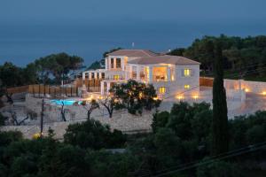 a large house with a pool in front of it at Tania Villas by PaxosRetreats in Gaios