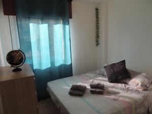 a bedroom with a bed with two towels on it at Accessible Cristimar in Los Cristianos +8 photos
