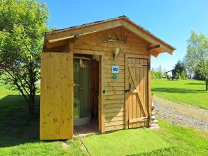 a wooden shed with a door in the grass at Domek SZAŁAS z jacuzzi, blisko Świeradów zdrój i zamek Czocha in Mirsk +22 photos