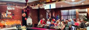 a group of people sitting at tables in a restaurant at Dartmoor Hotel Motel in Dartmoor