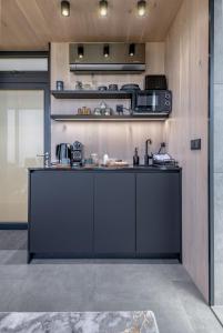a kitchen with a black counter in a room at The View At Lahill Craig - Duncan in Leven-Fife +10 photos