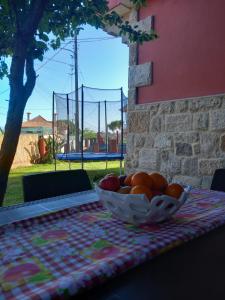 a bowl of fruit sitting on top of a table at A Redonda Vivienda Vacacional in Cangas de Morrazo