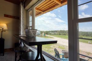 a room with a table and a window with a view at Meadow Cabin at Highland Meadows in Hot Springs