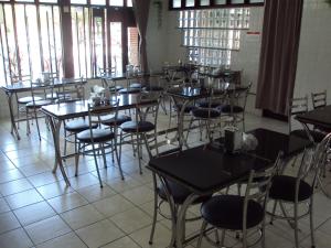 a room filled with tables and chairs and windows at Hotel Pousada Atlântica in João Pessoa +37 photos
