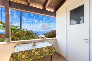 a table in a room with a view of a window at Salentoandmore - Villetta Salento in Marina San Gregorio