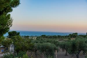a view of the ocean from a hill with trees at Casa Alyssa in Monte SantʼAngelo