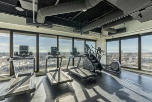 a gym with cardio equipment in a building with windows at Downtown Mountain Views Fire pit Free Pkg Gym in Salt Lake City