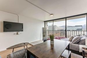 a living room with a couch and a table at Modern Mountain View Downtown Oasis Free Pkg Gym in Salt Lake City +23 photos