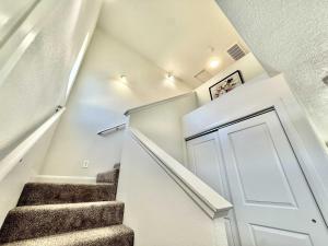 a staircase in a house with a white door at Townhome in Glendale UT near Zion with hot tub in Glendale +11 photos