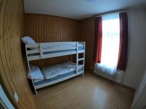 a room with two bunk beds and a window at Harderblick in Interlaken