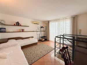 a living room with two beds and a window at Lydian Suite in Bari