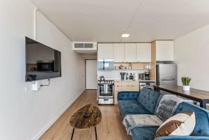 a living room with a blue couch and a table at High Rise 11th Floor City Views Free Pkg Gym in Salt Lake City