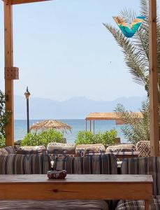 a living room with a couch and a view of the ocean at villa mando camp in Nuweiba