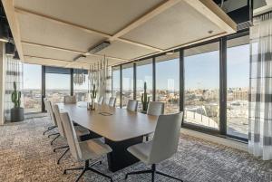 a dining room with a long table and chairs at High Rise 12th Floor City Views Free Pkg Gym in Salt Lake City