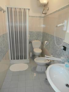 a bathroom with a toilet and a sink at Syrakosia a Ortigia in Syracuse +26 photos