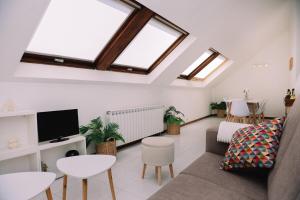 a living room with a couch and a tv at Vistas de lujo al lado del mar by CABANA Rentals in Moaña
