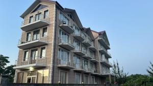 a building with balconies on the side of it at Golden Horizon House in Kobuleti