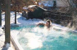 a woman in a hot tub in the snow at PARADISE SHARED SHORT STAy in Bowmanville