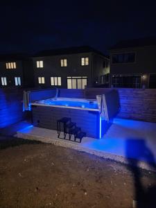 a pool with blue lighting in front of a building at PARADISE SHARED SHORT STAy in Bowmanville