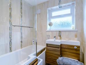 a bathroom with a tub and a sink and a shower at 3 Bed in Kielder 78280 in Falstone +22 photos