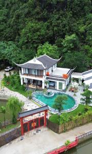 a large house with a swimming pool in the yard at Tam Coc Ecolodge in Vũ Lâm